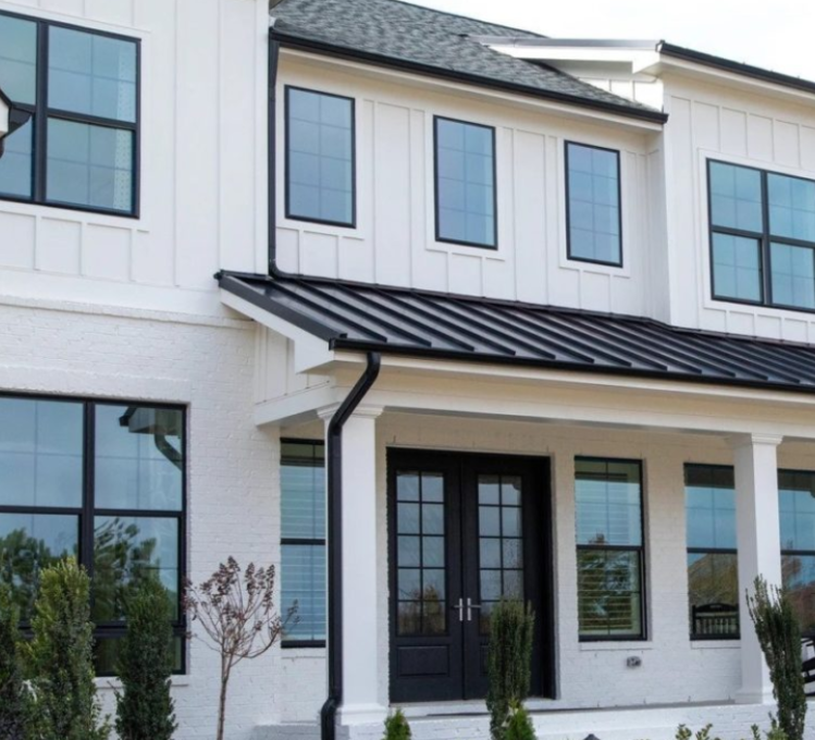 White fiber cement siding with black trim on a house.