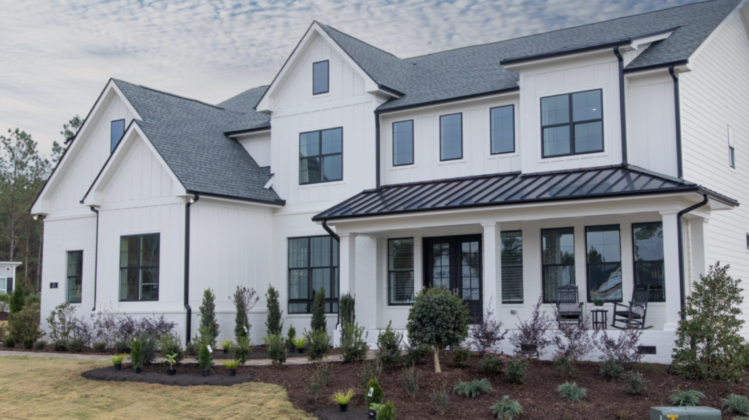 A white two-story fiber cement home with black accents.
