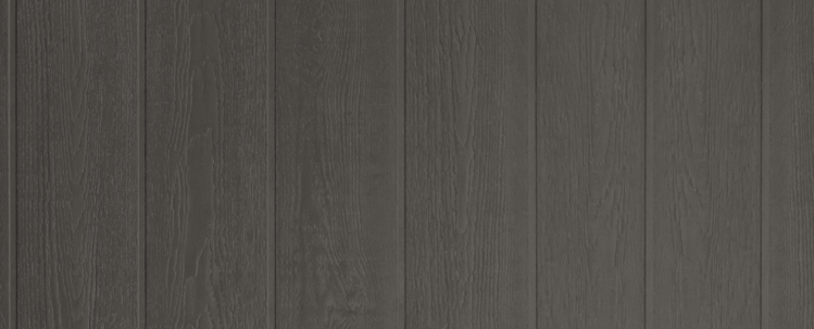 A close up image of dark grey board and batten siding for a house