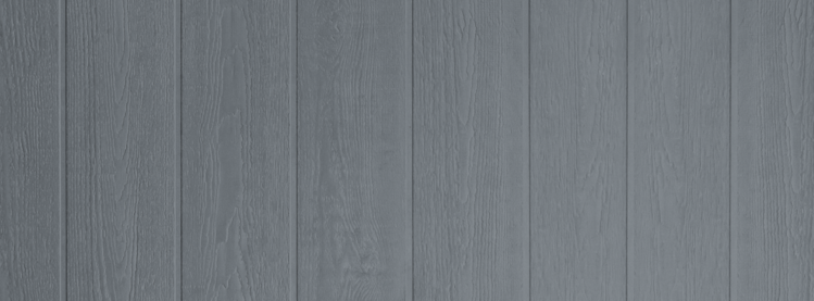 A close up image of light blue board and batten siding for a house